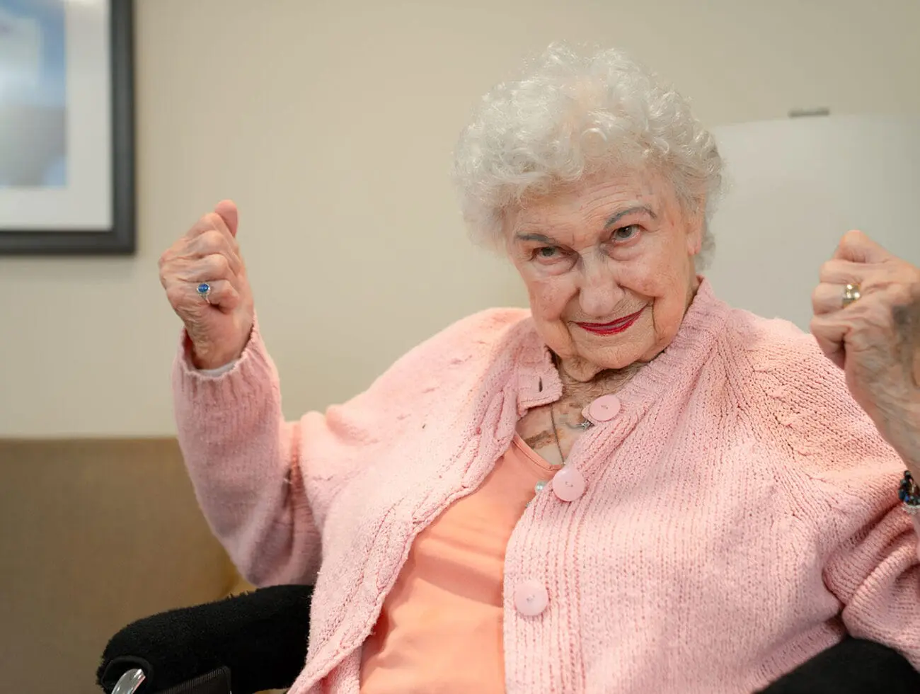 A woman clenching her fists looking accomplished as she achieves a goal.
