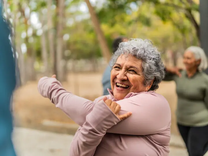 Older woman stretching outside
