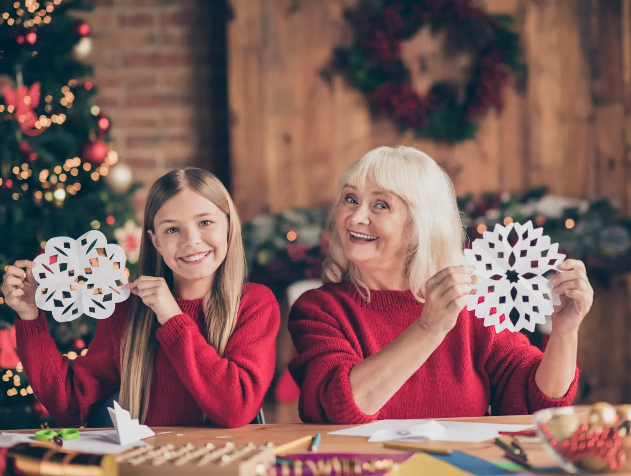 Senior woman and granddaughter enjoying christmas crafts for seniors