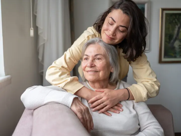 Adult daughter hugging senior mother