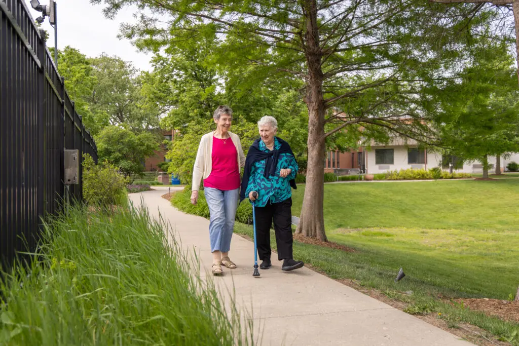 senior women walking on path at Central Baptist Village while discussing how to "rightsize your care".