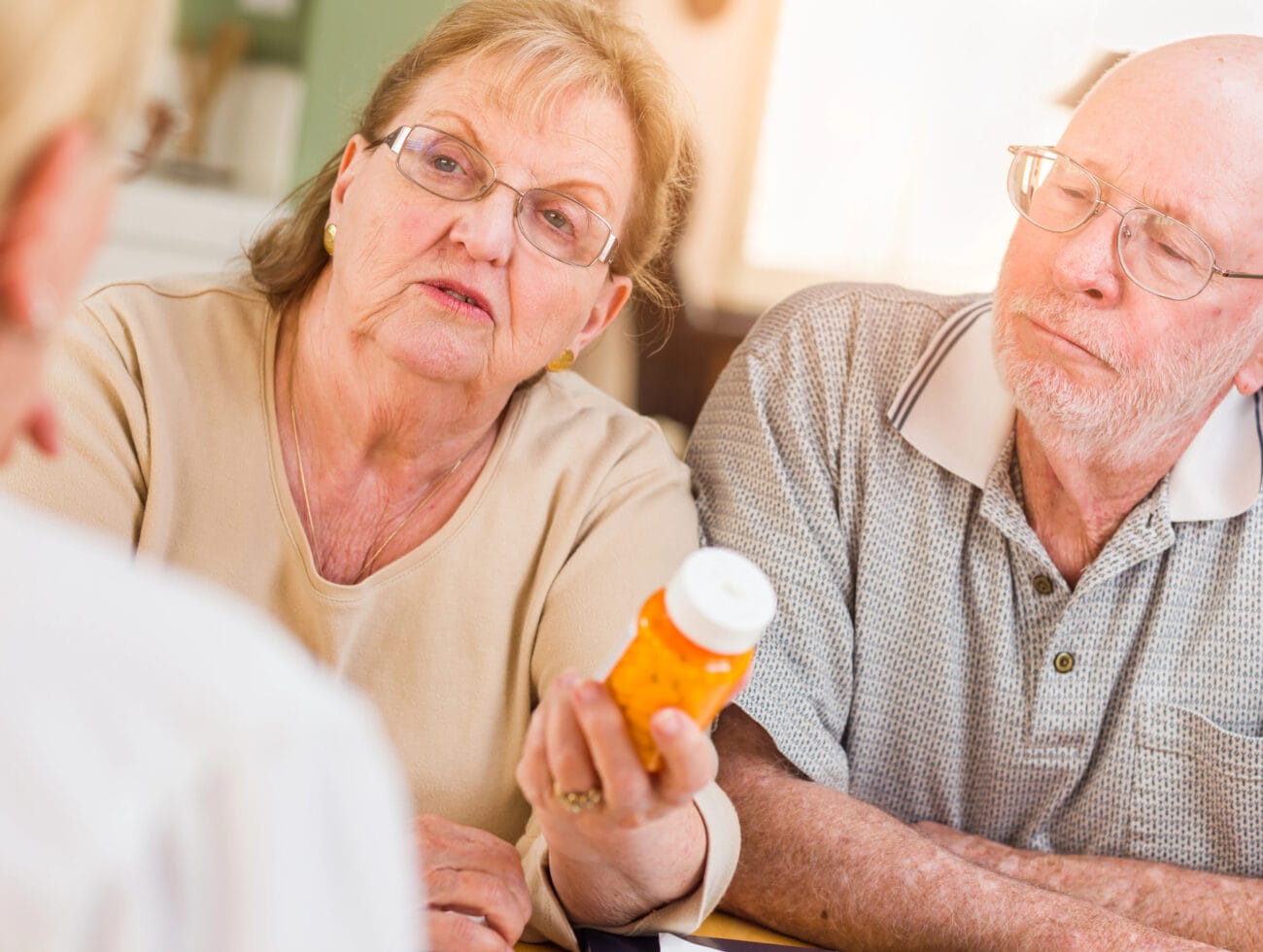 A man and woman discuss the mental health symptoms of dementia with their physician.