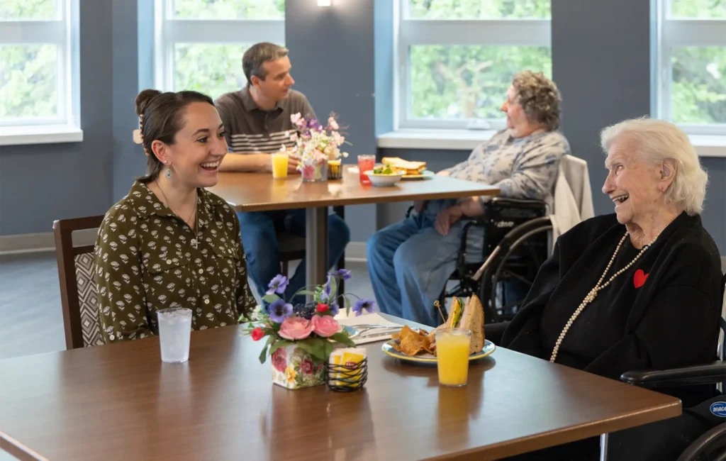 seniors at Central Baptist Village talking with friends and family while sharing a meal.