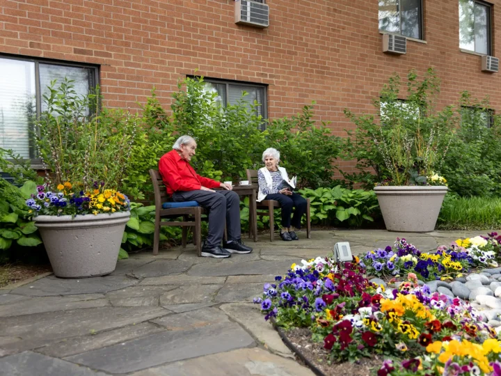 Residents sitting outdoors in the courtyard