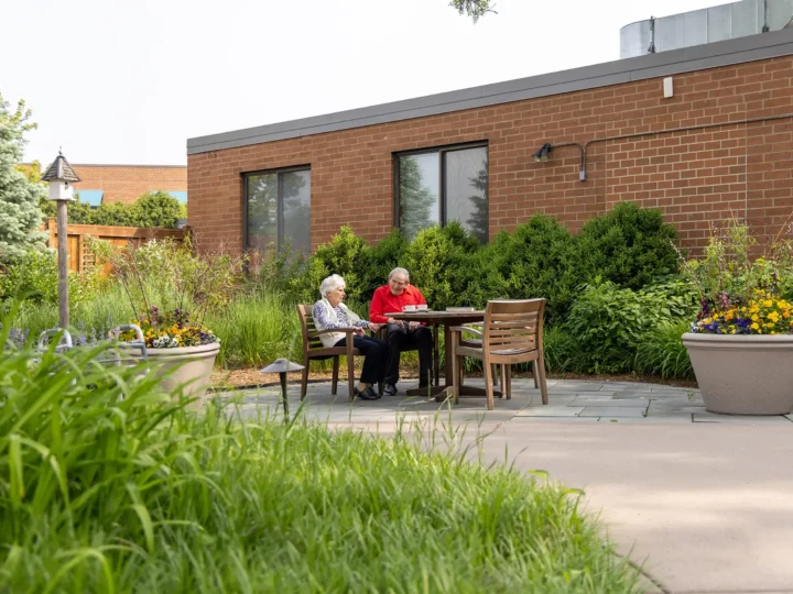Residents drinking coffee outside in the courtyard