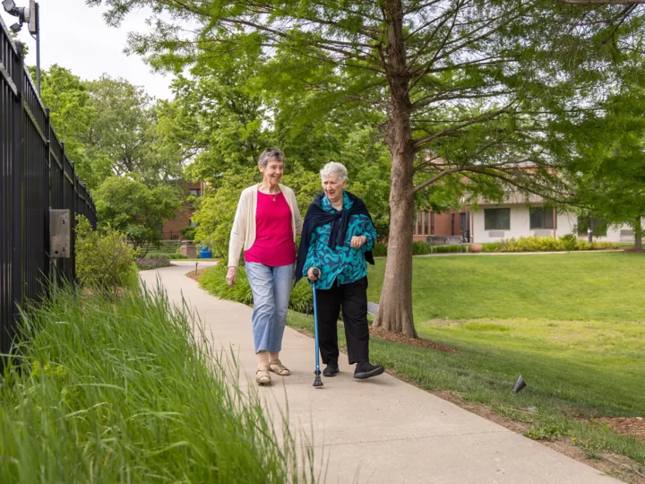 Two residents walking outdoors