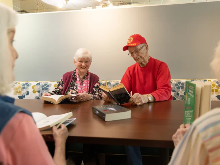 Residents reading together in the library