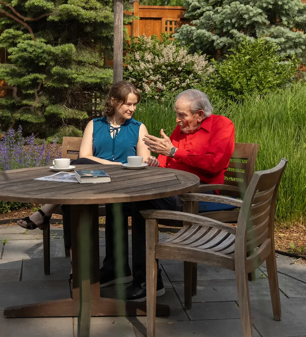 Senior woman chatting with her caregiver outdoors