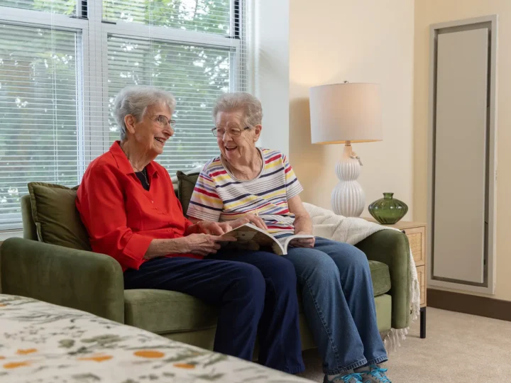 Resident laughing with a friend in her Apartment