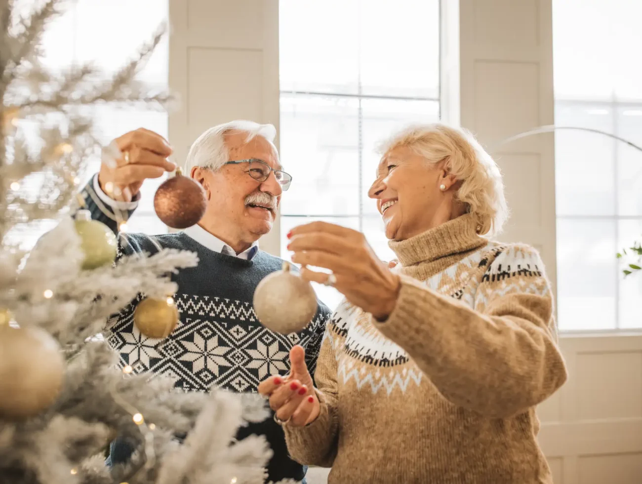 older couple decorates for the holidays
