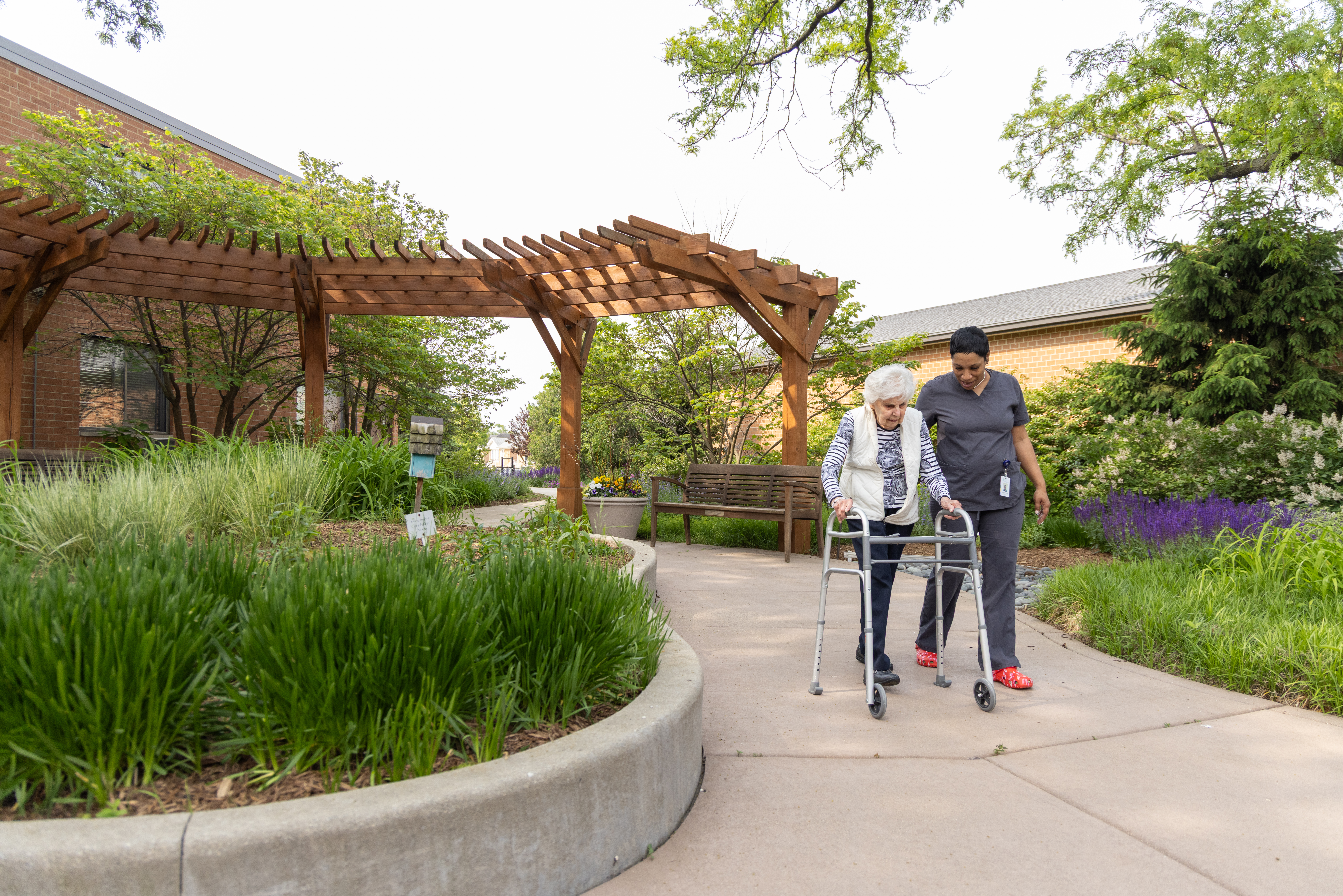 An elderly woman and her care giver walking around Central Baptist Village while discussing how to rightsize your care in retirement.
