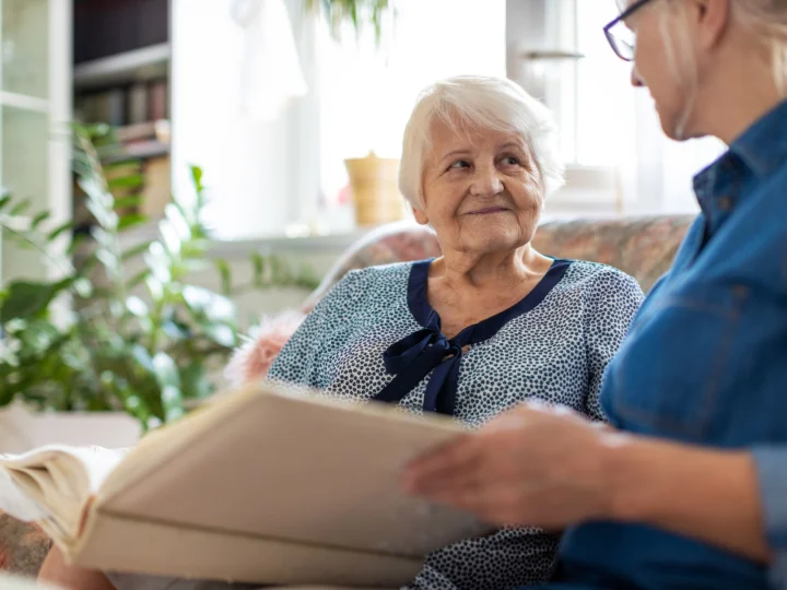 senior woman and older woman connecting over fun questions to ask someone with dementia from her home at Central Baptist Village in Norridge, IL.