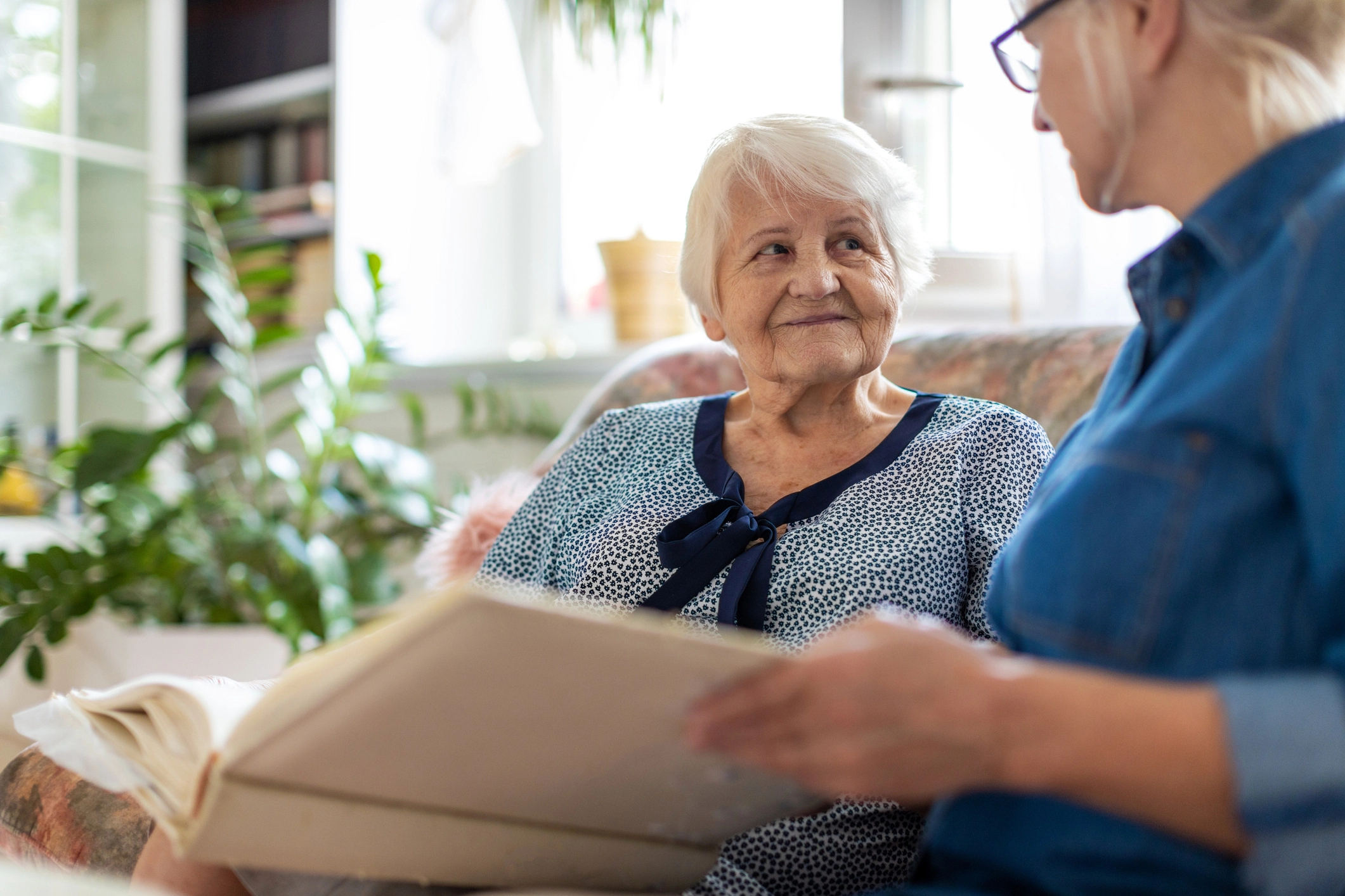senior woman and older woman connecting over fun questions to ask dementia patients